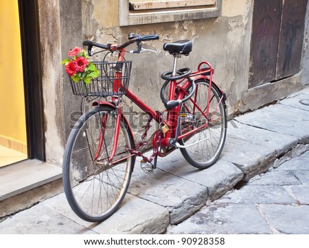 Retro bike in red with a bouquet of flowers in the basket