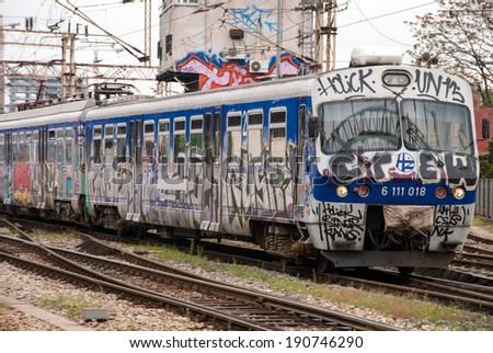 ZAGREB, CROATIA - April 12, 2014 - Train moving out of a station covered in graffiti in Zagreb, Croatia.