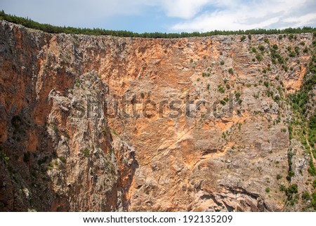 IMOTSKI, CROATIA - May, 31, 2012 - Cliffs above Red lake in Imotski, Croatia is a limestone crater, with it\'s cliffs 200 m high and lake 300 m deep.