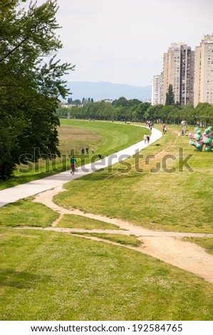 ZAGREB, CROATIA - May 11, 2014 - People walk, hike and ride bikes along the Sava river bank in Zagreb, Croatia.