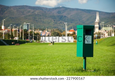 Zagreb, Croatia - October 18, 2014: Close up of bright green dog mess poop bin with label.