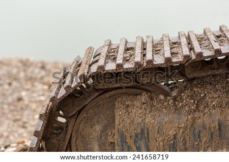 Detail of caterpillar track in construction site.