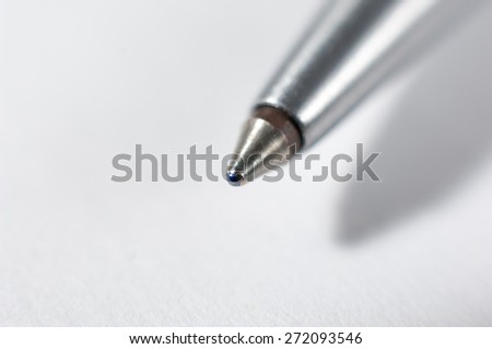 Pen tip against a white background.