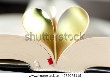 Pages of a Bible curved into a heart shape.