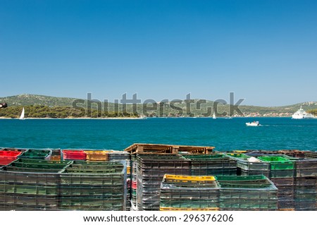 Colourful stack of fish crates on vessel.