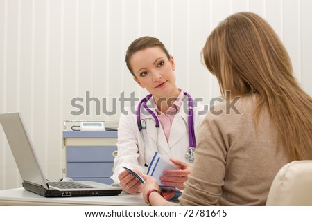 Doctor advises woman patient and writing prescription