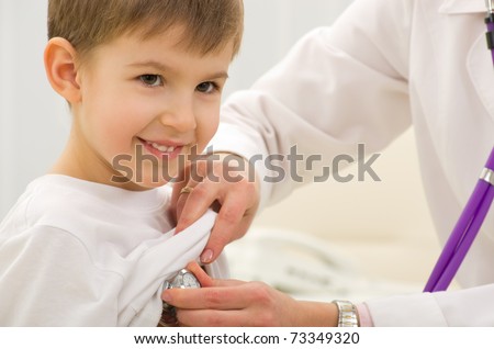 doctor listening to heartbeat of 4 years old boy in office