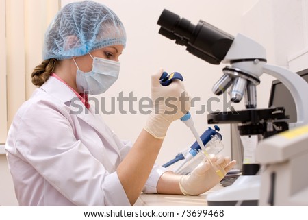 Young female doctor working with a microscope in a laboratory