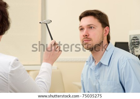 Woman doctor inspecting patient's nervous system