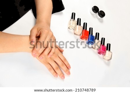 female hands and nail varnish vials