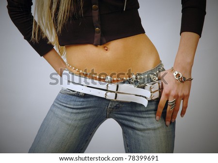 Fit woman belly wearing jeans and bijouterie