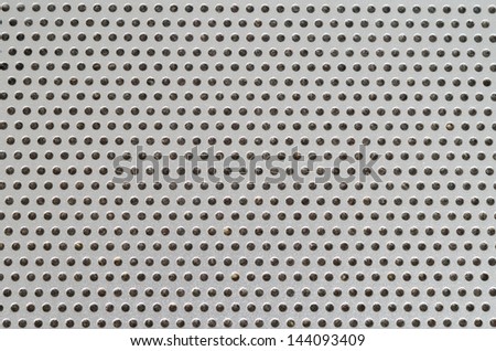 Laptop Speaker Hole grid metallic pattern macro with dust inside the holes