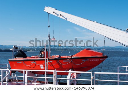 Lifeboat hanging on a deck of cruise ship