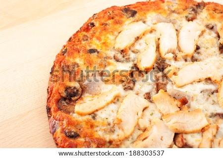 Chicken pizza on wooden cutting board