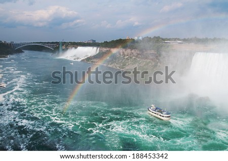 Beautiful rainbow forming near tourist boat at Niagara Falls, Ontario, Canada