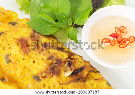 Banh Xeo, Vietnamese pancake close up shot with vegetables and fish sauce