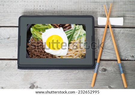 On-line and web asian food ordering concept with digital table and chopsticks