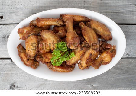 Close Up Deep Fried Chicken Wings on a wooden table