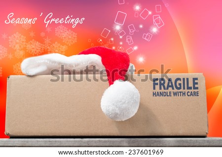 Season\'s Greetings with a Christmas purchase in a brown box on a wooden table