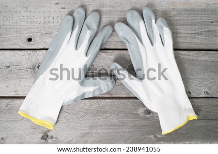 Pair of working gloves on vintage wooden table
