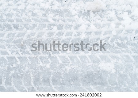 Close up of tire track on icy road after an ice storm