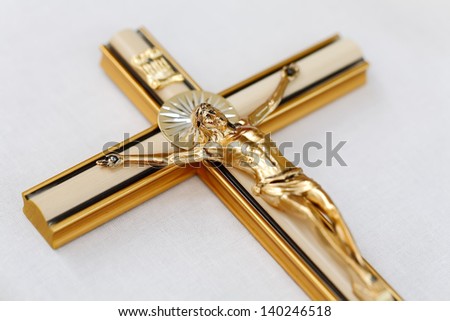 Wooden cross with Jesus Christ on the table, focused to Jesus face