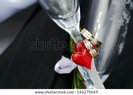 Wedding Rings and red heart on wedding glasses