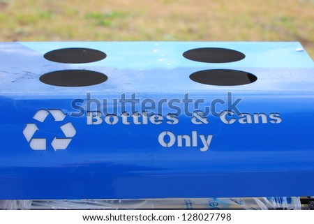 Close up of the top of a blue recycling bin