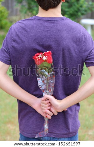 Someone Holding roses behind their back