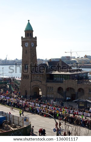 HAMBURG, GERMANY - APRIL 21: Impressions from the 28th Haspa Marathon on April 21, 2013, in Hamburg, Germany. Runners pass the historic Landungsbrucken port facilities.
