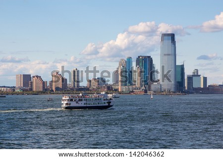 NEW YORK, NY, USA - SEPTEMBER 9: Statue Cruises ferry passes Jersey City on September 9, 2012 in New York, NY, USA. Closed since Superstorm Sandy, service to Liberty Island resumes July 2013.