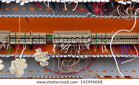 Detail of an obsolete, stripped electric switchboard with cut and town cables.