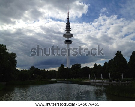 Heinrich Hertz Turm tv tower in Hamburg, Germany seen past lake at Planten un Bloomen park.