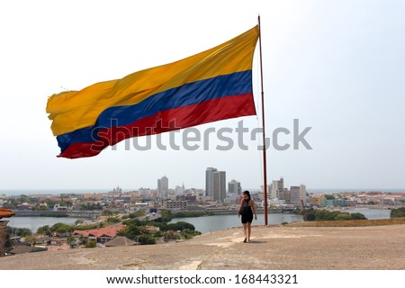 Colombian National Flag Streaming In The Caribbean Winds Above The Old Town Of Cartagena De Indias, Colombia.