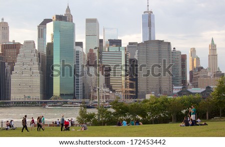 NEW YORK, NY, USA - CIRCA SEPTEMBER 2013: People enjoying the afternoon in Brooklyn Bridge Park before the backdrop of the Manhattan skyline on a mild fall day in Brooklyn, NY, USA in September 2013.