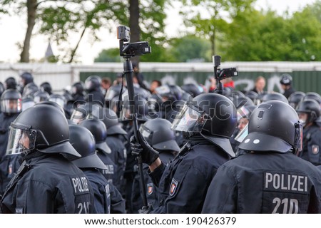 HAMBURG, GERMANY - MAY 1, 2014: police records protesters during the annual May Day demonstration in Hamburg, Germany on May 1, 2014.