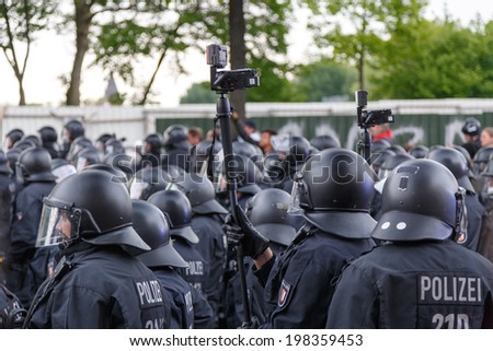HAMBURG, GERMANY - MAY 1, 2014: police records protesters during the annual May Day demonstration in Hamburg, Germany on May 1, 2014.