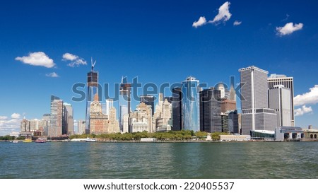 Southern tip of Manhattan with the Financial District as seen from a boat in New York harbor in New York, NY, USA.
