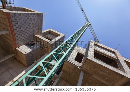 crane and unfinished apartments - construction site