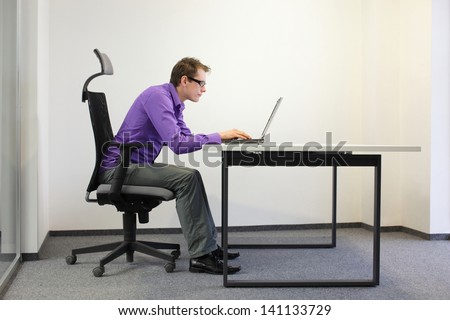 Bad Sitting Posture At Laptop .Short-Sighted Business Man On Chair In His Office