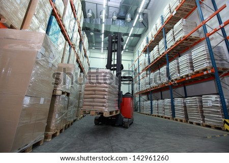 Forklift loader with pallet of sacks in distribution warehouse