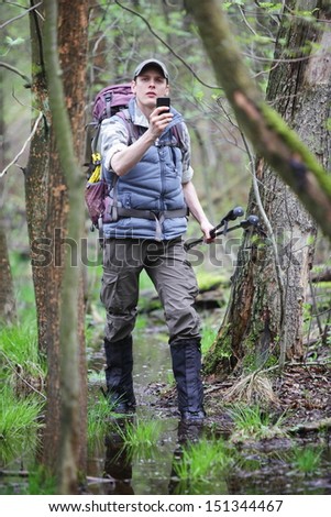 Lost Hiker In Forest With Mobile Satellite Navigation Device - Geo-Caching