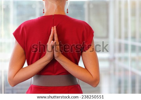 Fit woman - namaste gesture on back - close up