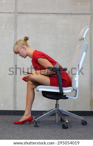 break at work in office - relax on chair - business woman exercising