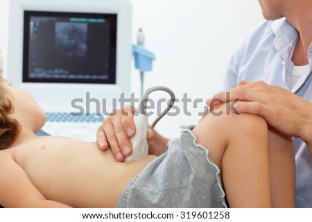 Child\'s abdominal cavity diagnosis carried out with the use of an ultrasound