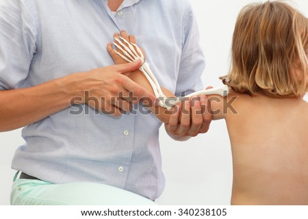 anatomy lesson - presentation of child\'s upper limb skeletal system