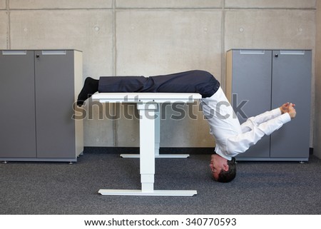 yoga in office. business man exercising at workplace