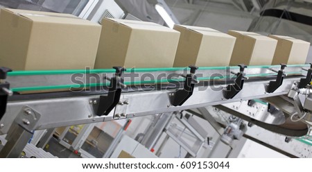Automation - Cardboard boxes on conveyor belt in factory