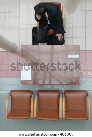 Adult man sitting on the chair and waiting for interview - 1