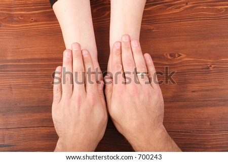 woman\'s hands covered by man\'s hands